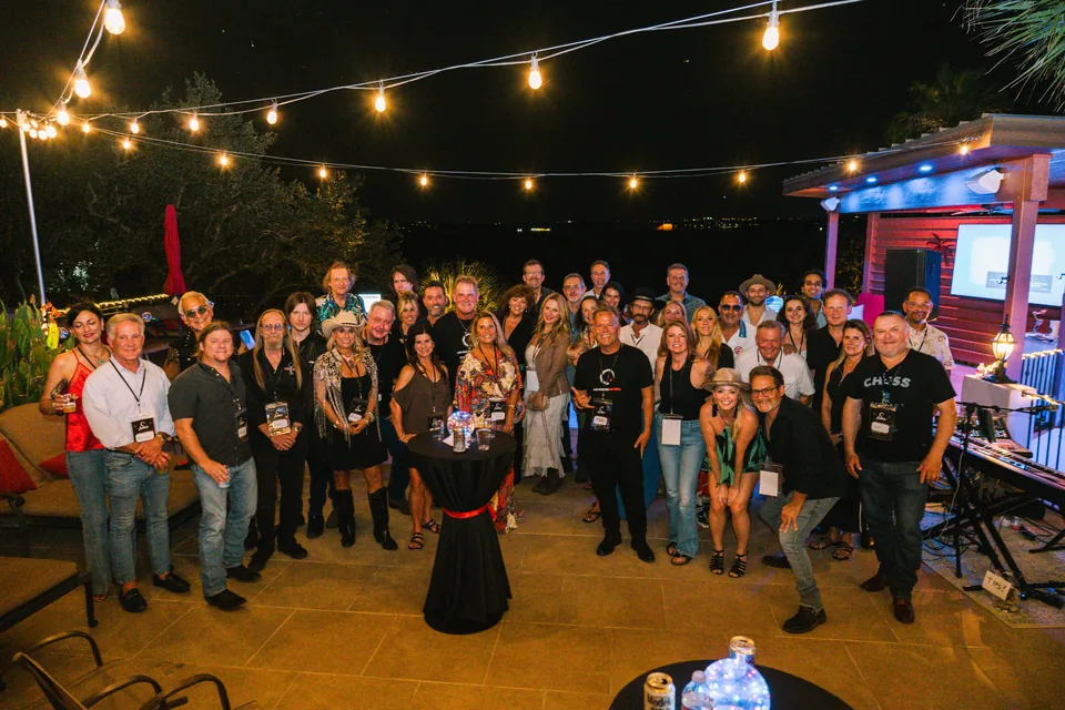AMPD launch group photo beneath string lights